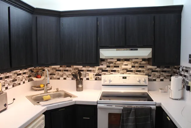 a kitchen with a sink and a stove top oven