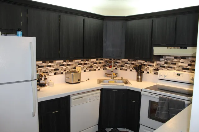a kitchen with a sink and a refrigerator