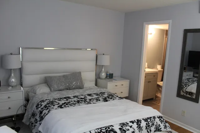 a bedroom with a bed and a tv on the dresser