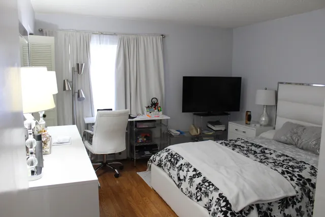 a bedroom with a bed and a flat screen tv
