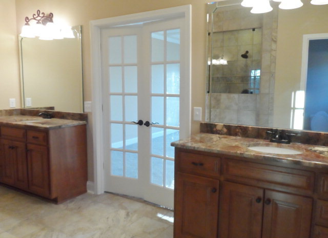 346 Eagle Ridge Road Macon, GA 31216 - Photo 14 of 30 a bathroom with a granite countertop sink a mirror and a shower