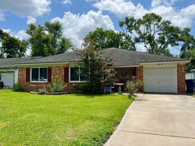 a view of a house with a yard and a garden