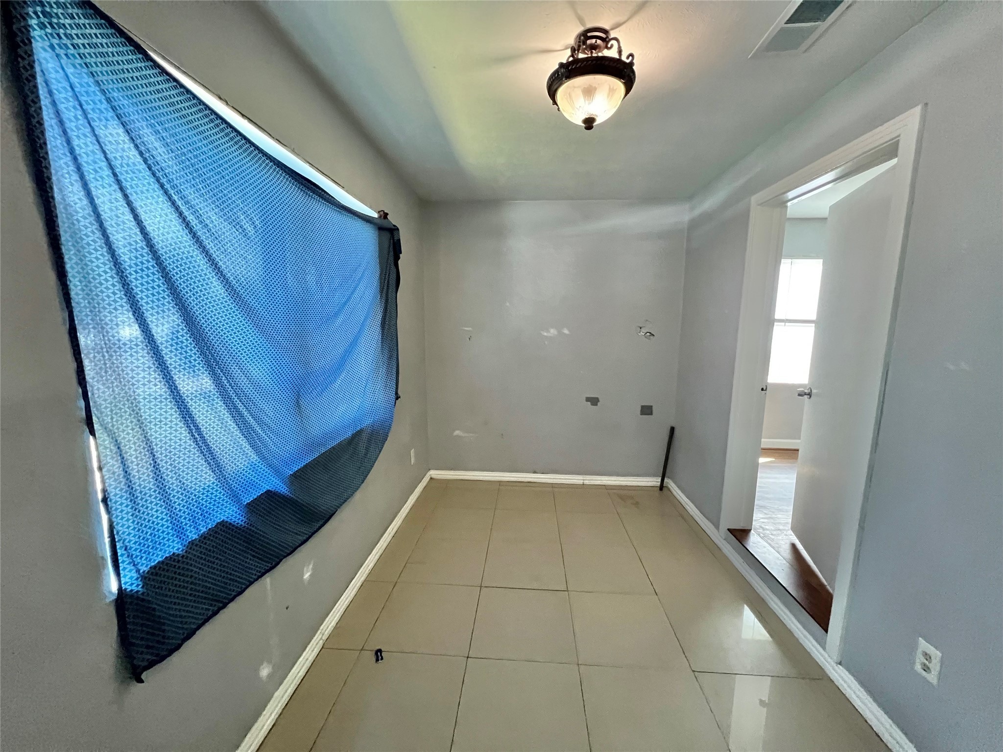 424 Evans Street Angleton, TX 77515 - Photo 13 of 20 a view of an empty room with a window