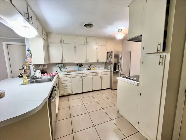 a kitchen that has a sink and cabinets