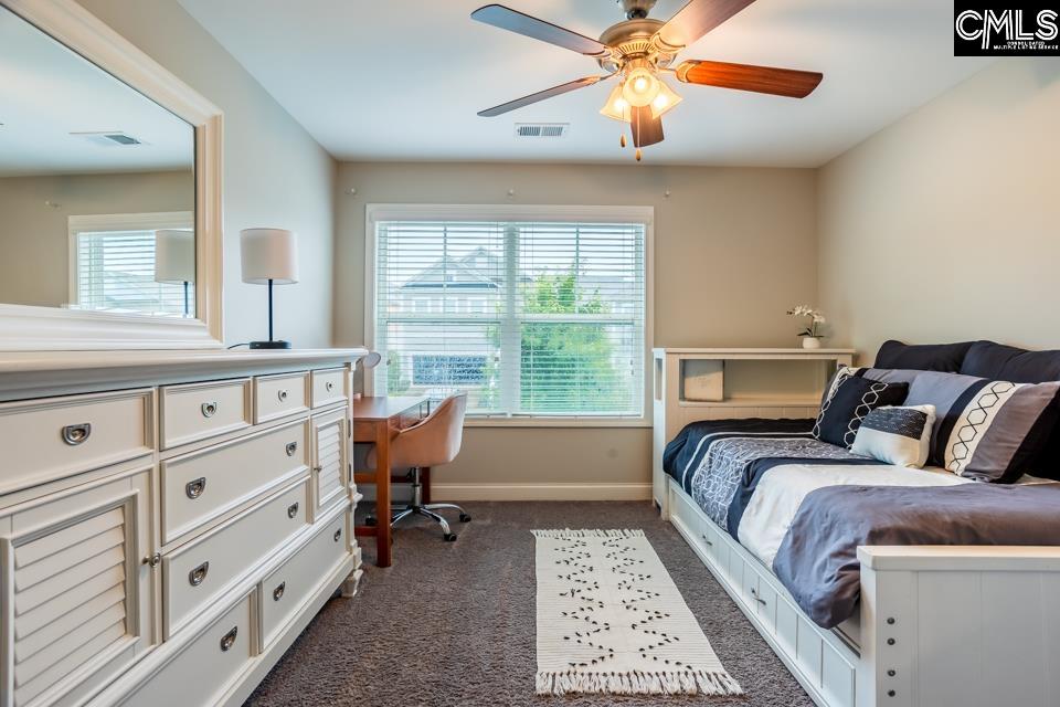 357 Cabana Way Lexington, SC 29072 - Photo 14 of 25 a bed room with a bed and a chandelier