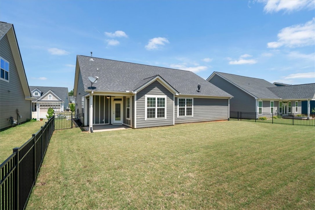 21 Barron Glenn Way Anderson, SC 29621 - Photo 42 of 48 A well-maintained lawn and fenced yard complements this charming home's rear exterior and patio space.