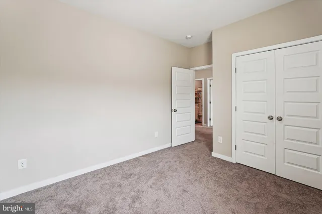 an empty room with closet area