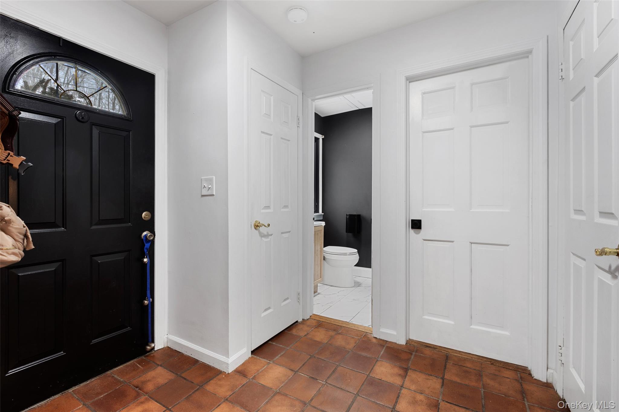 Tiled entry leads to the open living room