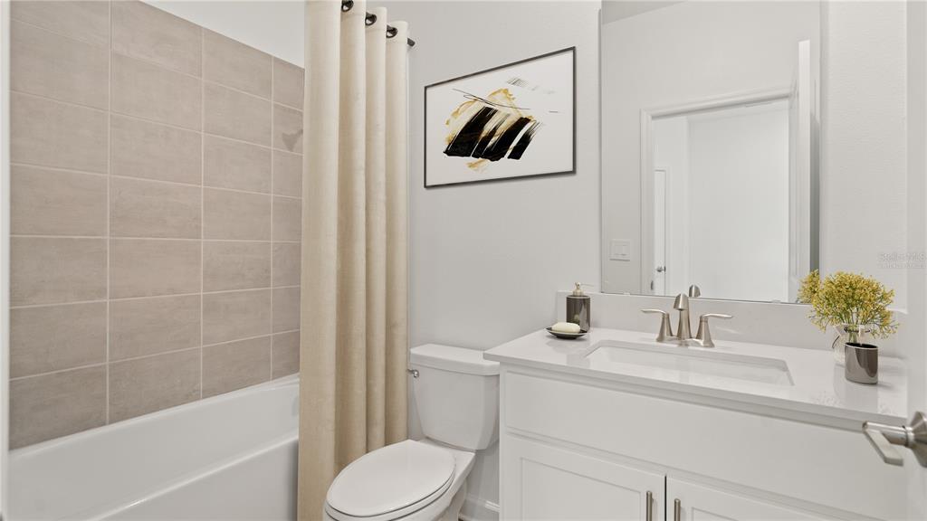 7851 Poplin Street Kissimmee, FL 34747 - Photo 11 of 36 a bathroom with a sink a toilet and shower