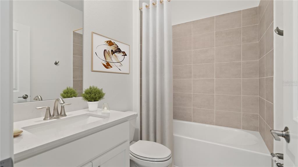 7851 Poplin Street Kissimmee, FL 34747 - Photo 12 of 36 a bathroom with a sink a toilet and bathtub