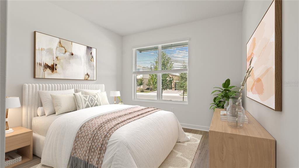 7851 Poplin Street Kissimmee, FL 34747 - Photo 13 of 36 a bedroom with a bed painting and wooden floor