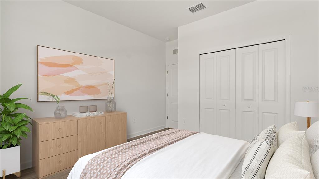 7851 Poplin Street Kissimmee, FL 34747 - Photo 14 of 36 a bedroom with a bed and a painting on the wall