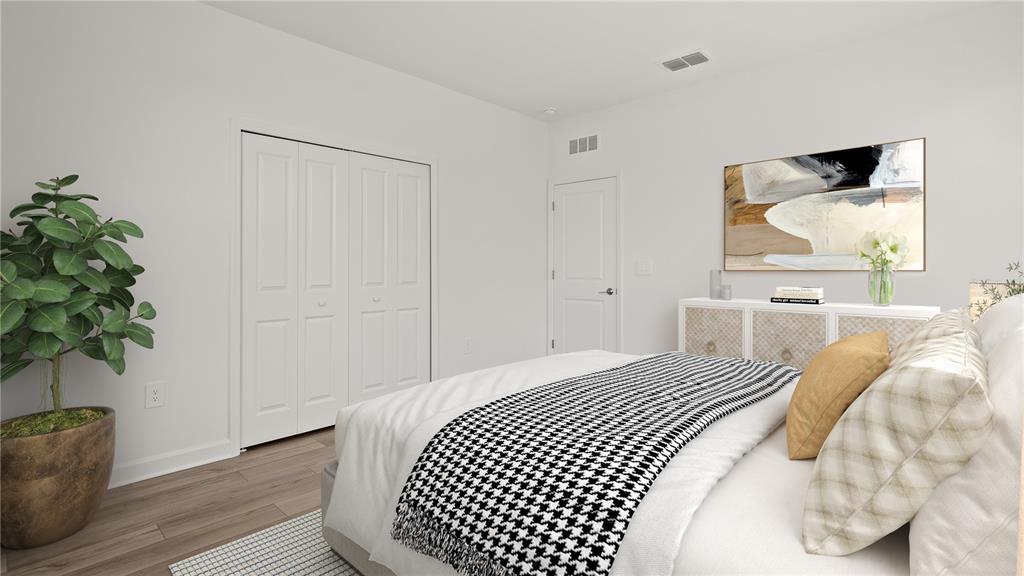 7851 Poplin Street Kissimmee, FL 34747 - Photo 16 of 36 a bedroom with a bed and a potted plant