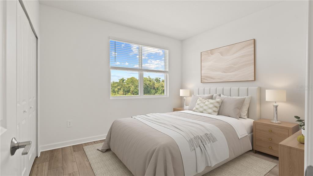 7851 Poplin Street Kissimmee, FL 34747 - Photo 18 of 36 a bedroom with a bed and a painting on the wall