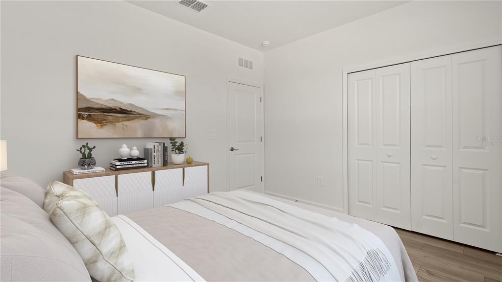 7851 Poplin Street Kissimmee, FL 34747 - Photo 19 of 36 a bedroom with a bed a table and painting on the wall