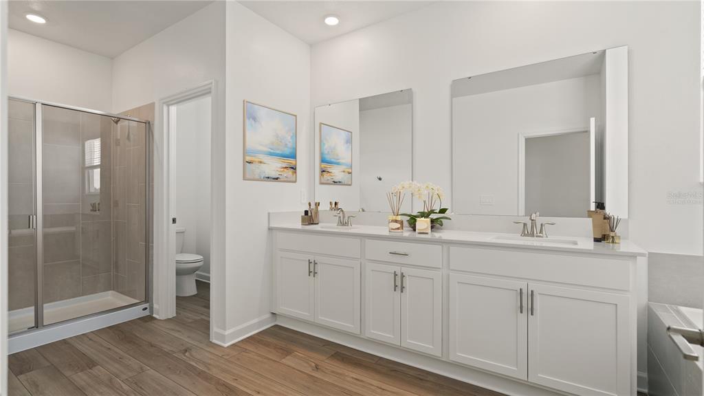 7851 Poplin Street Kissimmee, FL 34747 - Photo 24 of 36 a bathroom with a double vanity sink and mirror