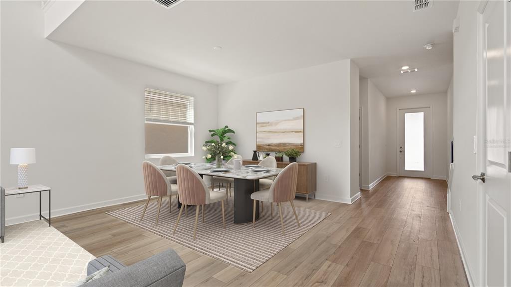 7851 Poplin Street Kissimmee, FL 34747 - Photo 6 of 36 a view of a dining room with furniture and wooden floor