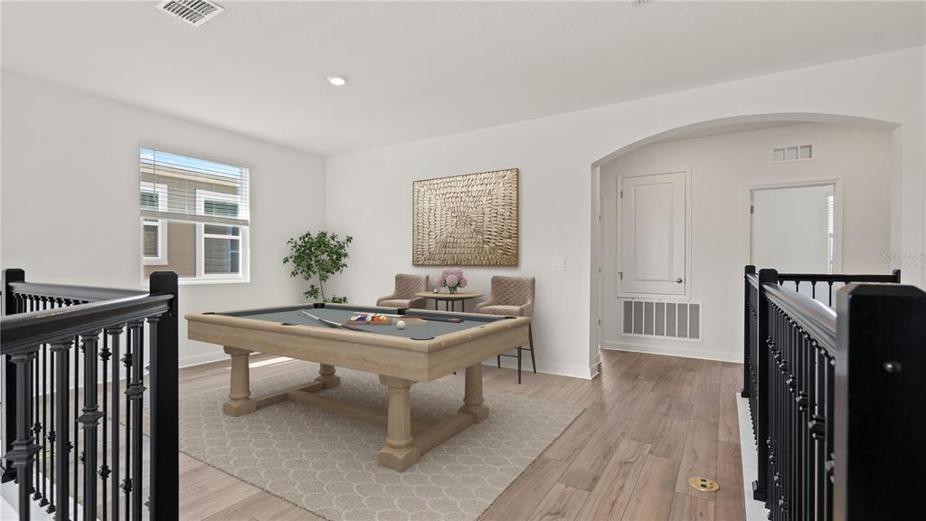 7851 Poplin Street Kissimmee, FL 34747 - Photo 8 of 36 a living room with furniture a dining table wooden floor and a large window