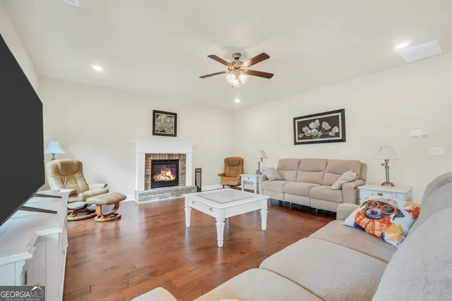 a large kitchen with stainless steel appliances granite countertop a sink counter space and wooden floor