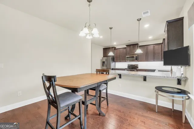 a kitchen with kitchen island a counter space a sink appliances and cabinets