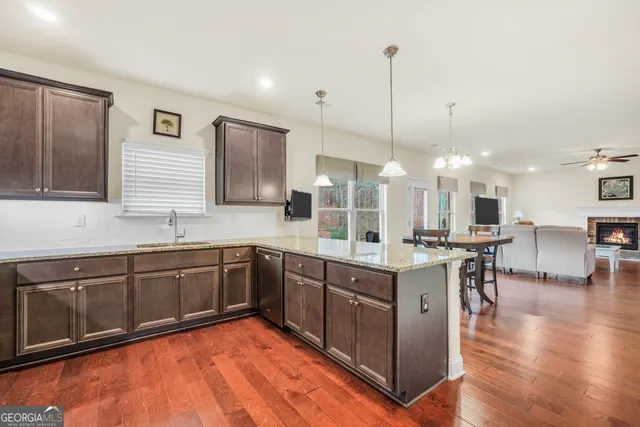 a large kitchen with stainless steel appliances lots of counter space and a sink