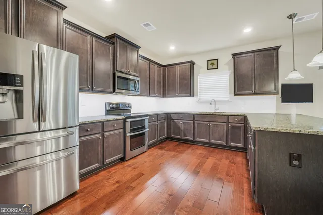 a view of a dining room with furniture and wooden floor