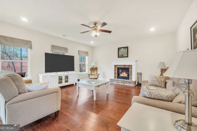 a living room with furniture and wooden floor
