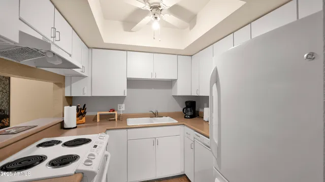a kitchen with a sink a stove and cabinets