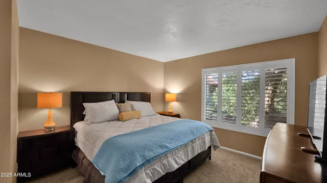 a bedroom with a bed and window