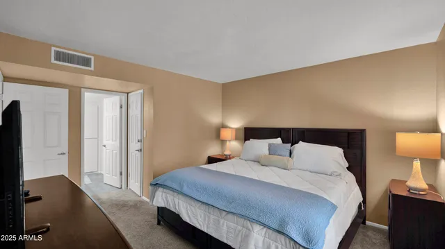 a bedroom with a bed and a lamp on table