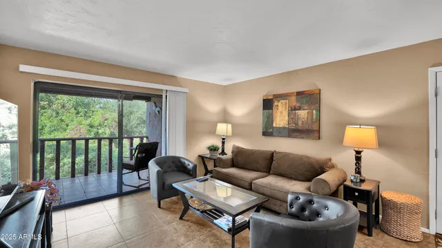 a living room with furniture and a lamp