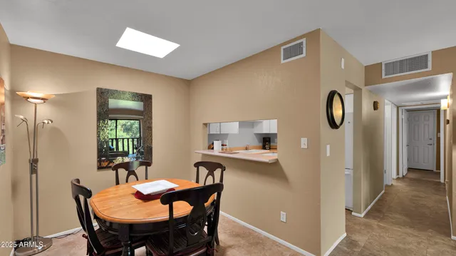 a view of a dining room with furniture and window