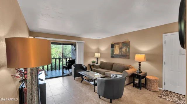 a living room with furniture and a lamp