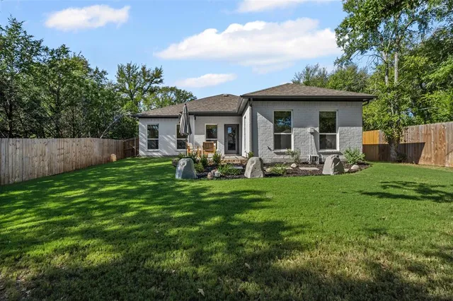 a view of a house with a backyard and a patio