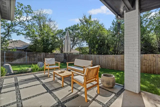a view of backyard with a patio and outdoor seating