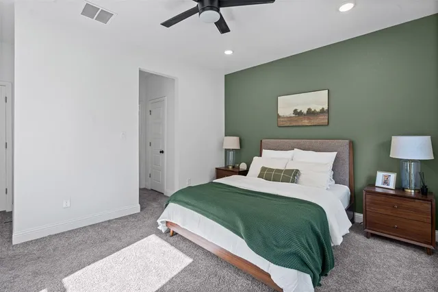 a bedroom with a bed and a painting on the wall