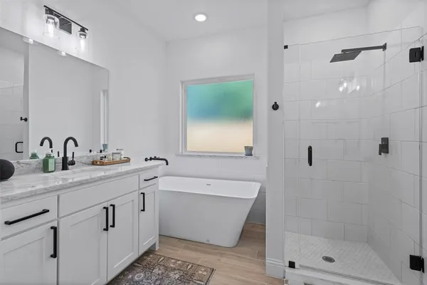 a bathroom with a double vanity sink mirror and shower