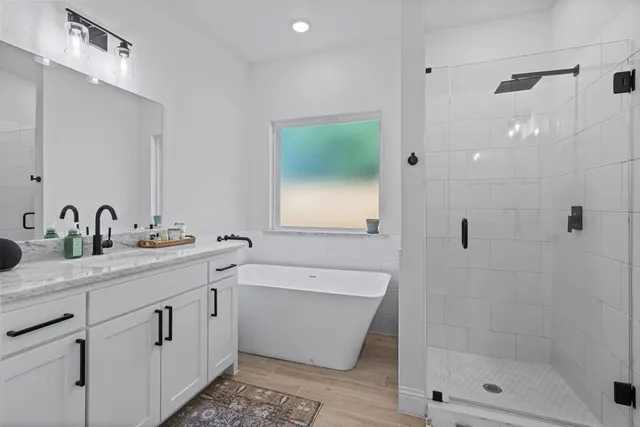 a bathroom with a double vanity sink mirror and shower