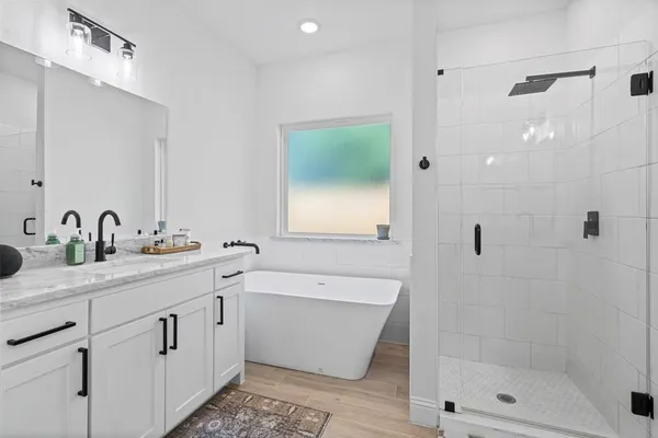 a bathroom with a double vanity sink mirror and shower