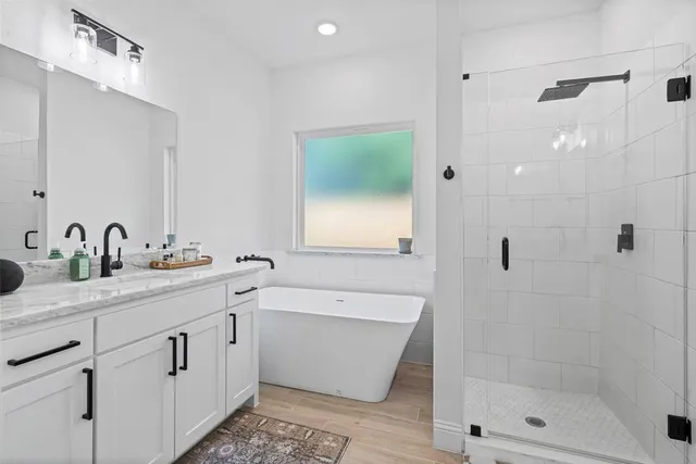 a bathroom with a double vanity sink mirror and shower