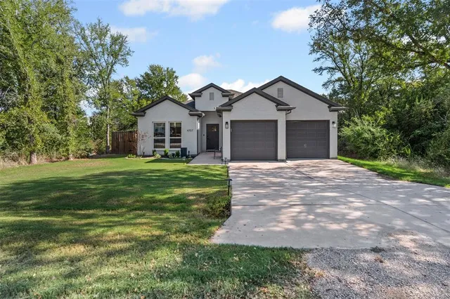 a front view of house with yard and green space