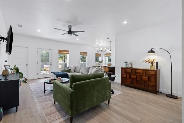 a living room with furniture a ceiling fan and a window
