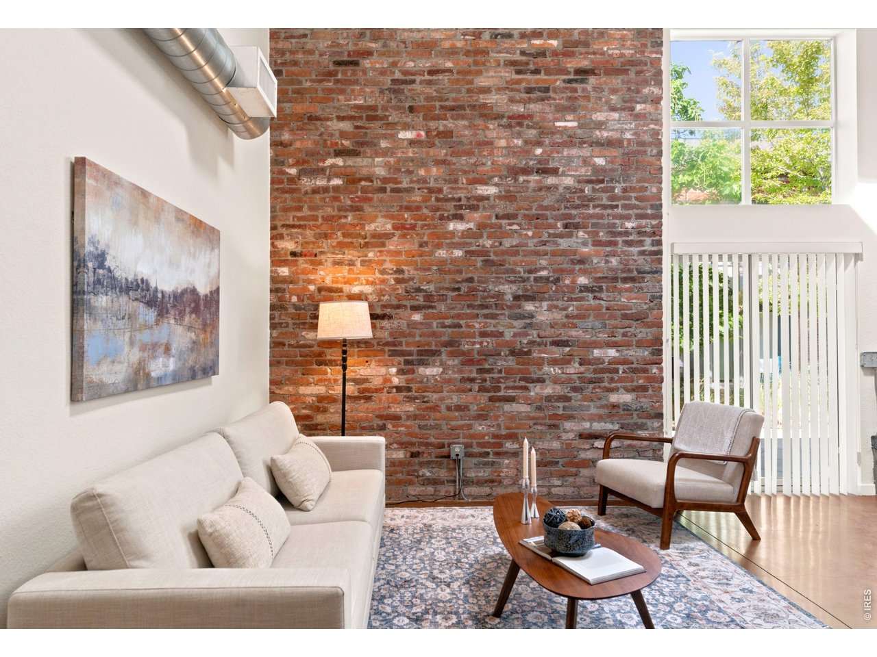 3033 Blake Street, Unit 112 Denver, CO 80205 - Photo 2 of 28 a living room with furniture and a floor to ceiling window