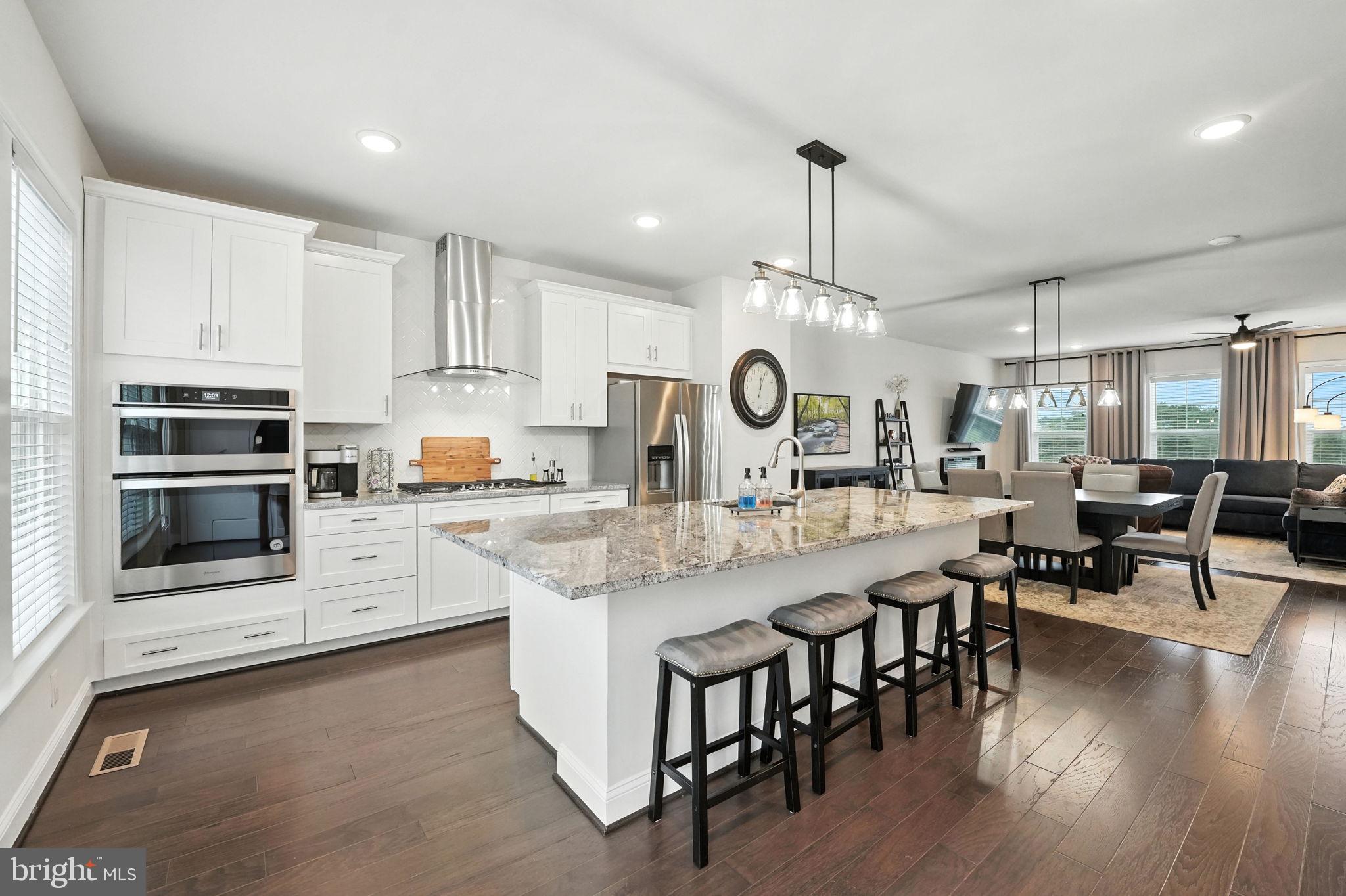 17233 Branched Oak Road Dumfries, VA 22026 - Photo 16 of 79 a large kitchen with stainless steel appliances a large center island attached withe living room