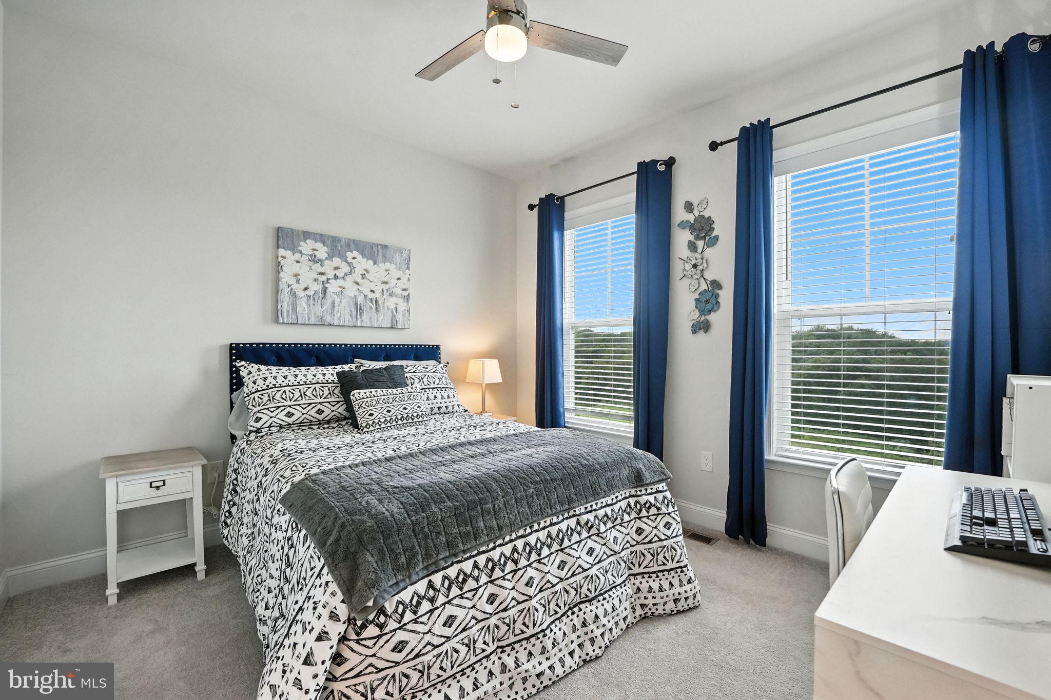 17233 Branched Oak Road Dumfries, VA 22026 - Photo 32 of 79 a bedroom with a bed a couch and a window