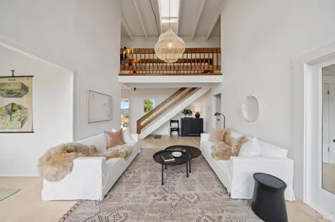 a living room with furniture and a clock