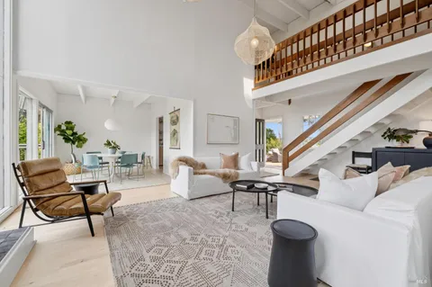 a living room with patio furniture and a book shelf