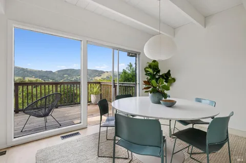 a dining room with a glass top table and chairs