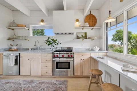 a kitchen with stainless steel appliances a stove a sink and a refrigerator