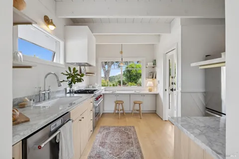 a spacious bathroom with a granite countertop sink and a bathtub
